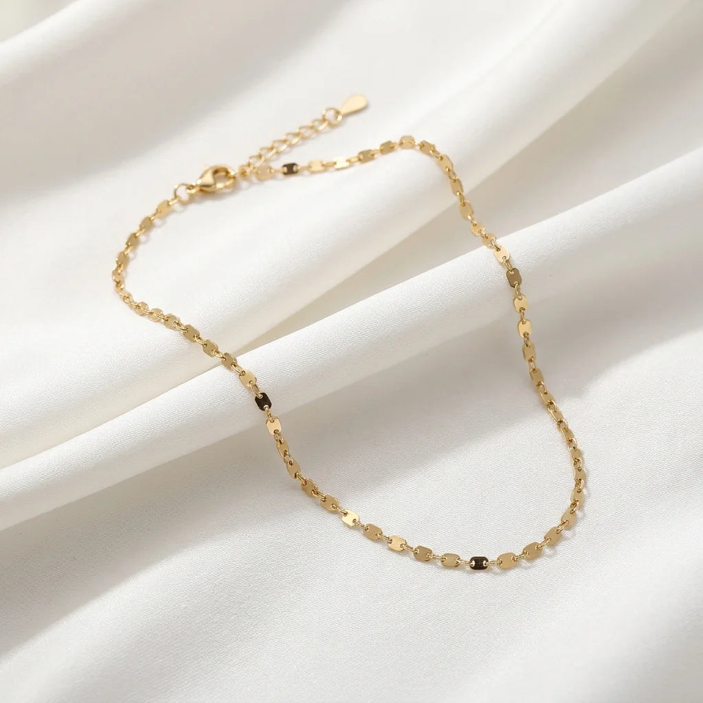 18K Gold Vermeil Rolo Chain Necklace — Detailed product view of a minimalist gold necklace laid on white fabric, showcasing