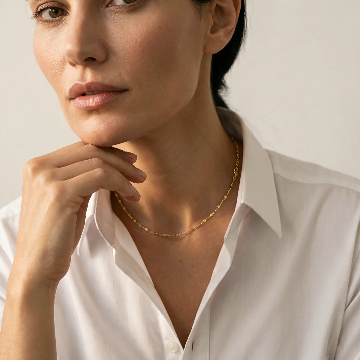 18K Gold Vermeil Rolo Chain Necklace — Lifestyle portrait of a woman wearing a delicate gold necklace with a white shirt